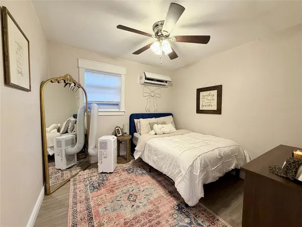 a bedroom with a bed and ceiling fan