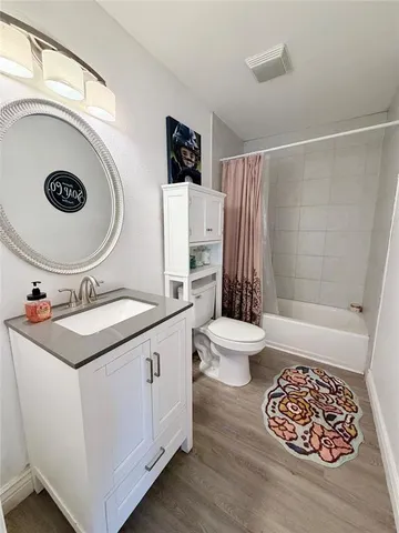 a bathroom with a sink a toilet and a shower