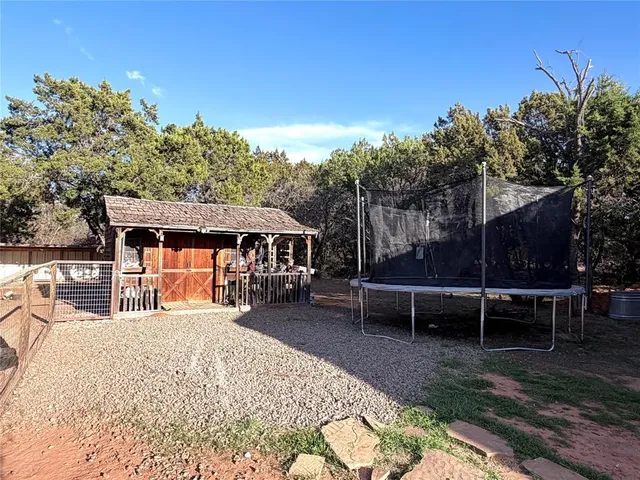 a backyard of a house with barbeque oven and outdoor seating