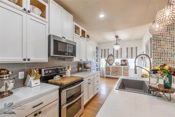 a kitchen with stainless steel appliances granite countertop a stove and a sink