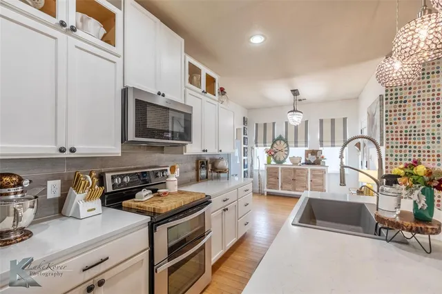 a kitchen with stainless steel appliances granite countertop a stove and a sink