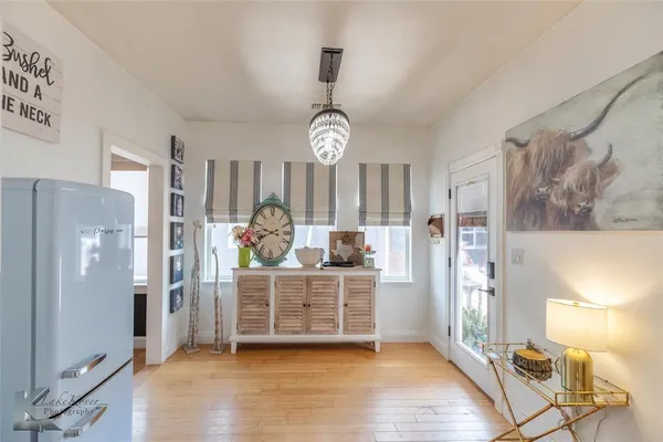 a view of a kitchen with refrigerator and window