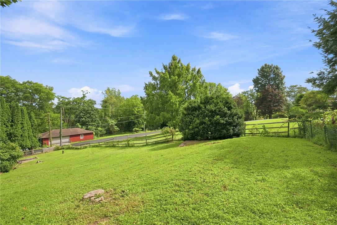3408 Oak Hill Road Emmaus, PA 18049 - Photo 56 of 93 A spacious grassy lawn slopes gently toward mature trees and a scenic wood fence.