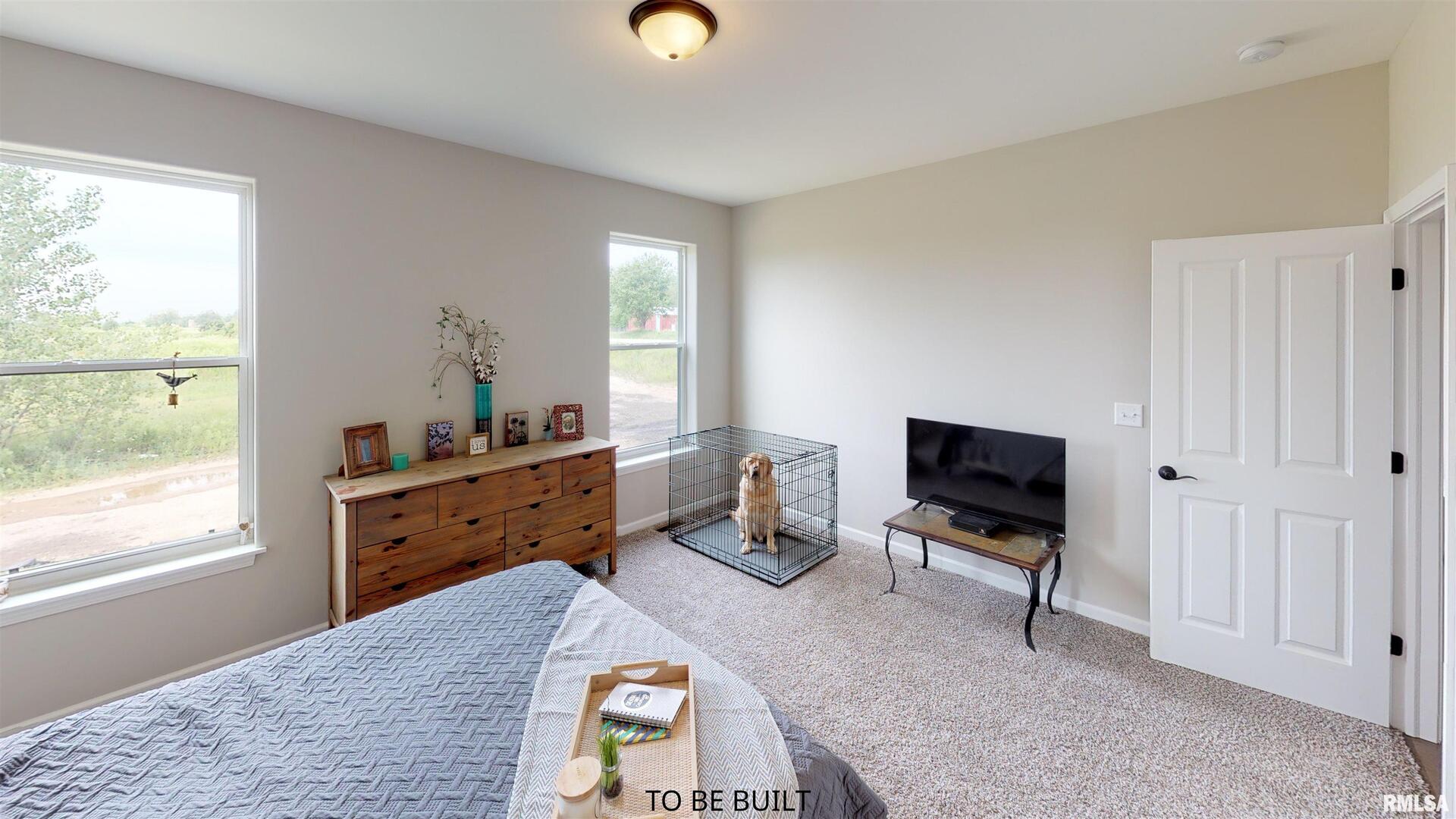 6 South 5th Street Eldridge, IA 52748 - Photo 14 of 17 a bed room with furniture and a window