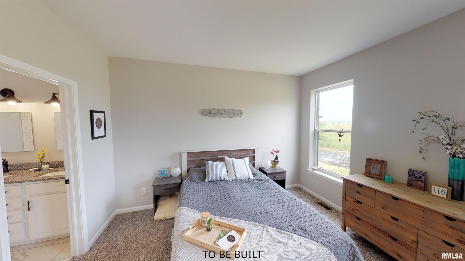 6 South 5th Street Eldridge, IA 52748 - Photo 16 of 17 a bedroom with a bed and wooden floor