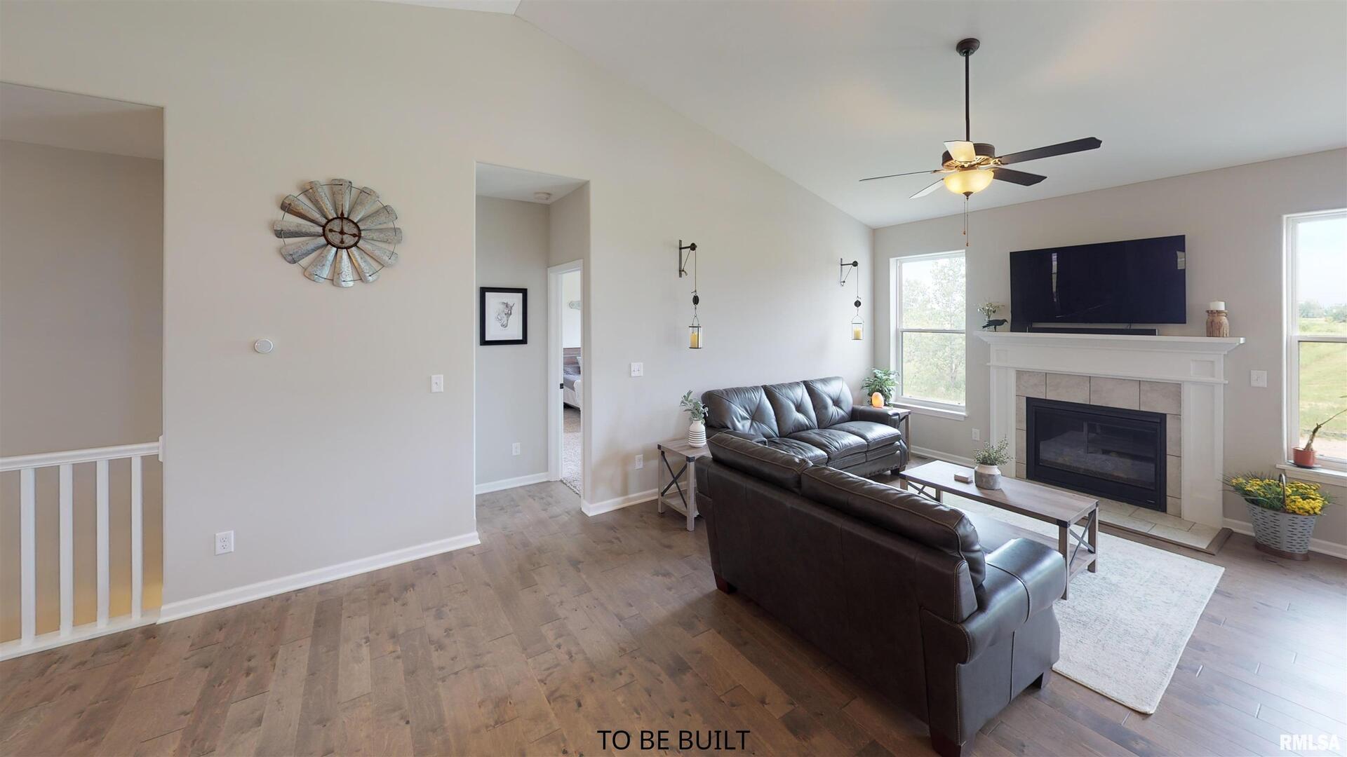 6 South 5th Street Eldridge, IA 52748 - Photo 8 of 17 a living room with furniture a fireplace and a flat screen tv
