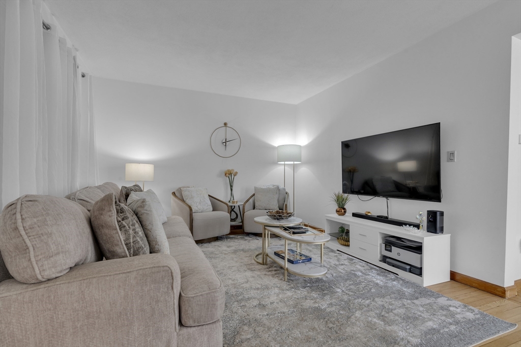 64 Commonwealth Road Watertown, MA 02472 - Photo 7 of 23 a living room with furniture and a flat screen tv