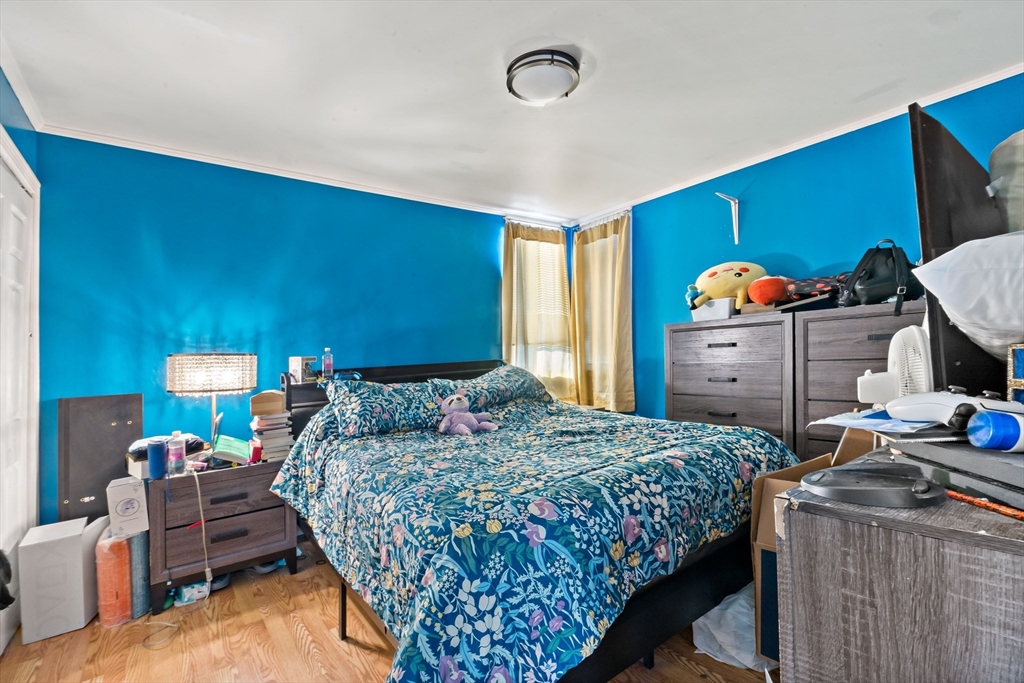 677 Oak Grove Avenue Fall River, MA 02720 - Photo 11 of 26 a bedroom with a bed and a dresser