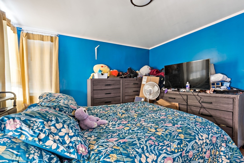 677 Oak Grove Avenue Fall River, MA 02720 - Photo 12 of 26 a bedroom with a bed and a flat screen tv
