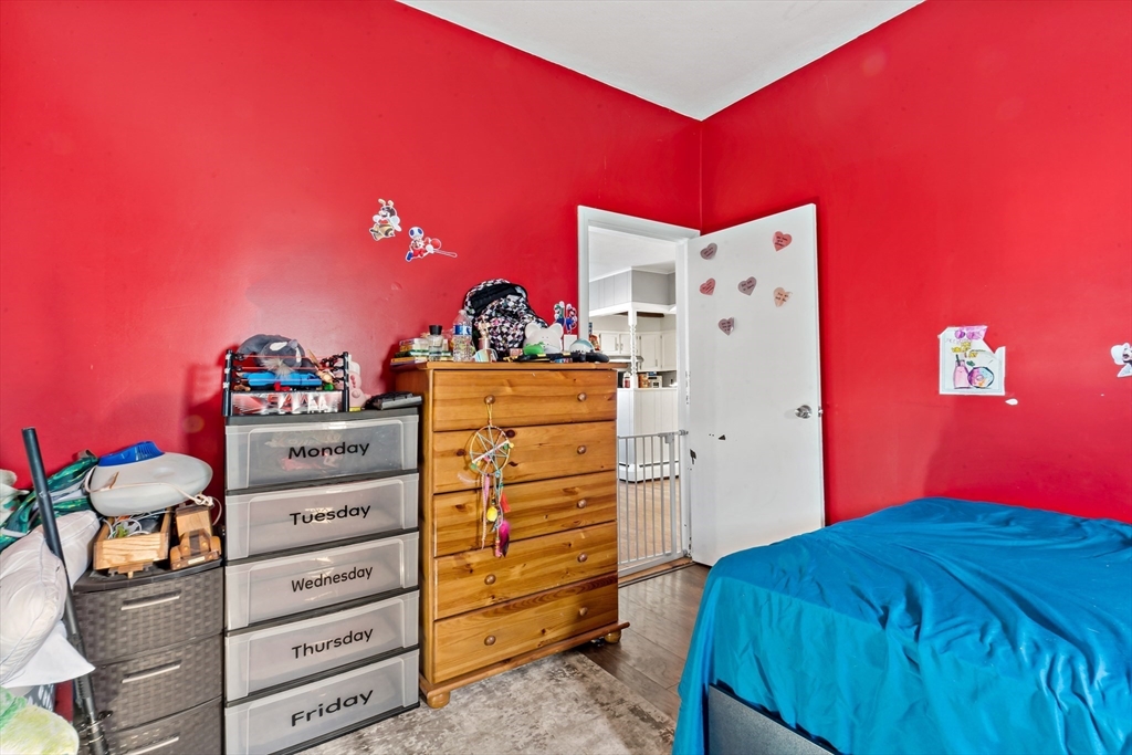 677 Oak Grove Avenue Fall River, MA 02720 - Photo 6 of 26 a bedroom with a bed and a dresser