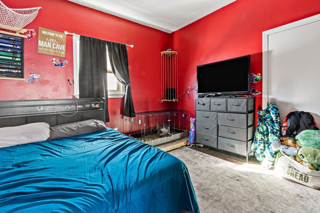 677 Oak Grove Avenue Fall River, MA 02720 - Photo 7 of 26 a bedroom with bed and a flat screen tv