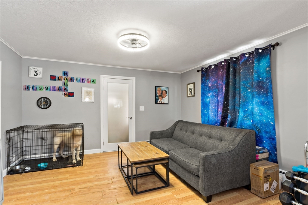 677 Oak Grove Avenue Fall River, MA 02720 - Photo 10 of 26 a living room with furniture and a flat screen tv