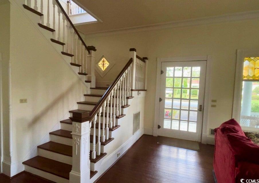 309 North Academy Street Kingstree, SC 29556 - Photo 5 of 38 Doorway featuring ornamental molding, wood finished floors, and stairway