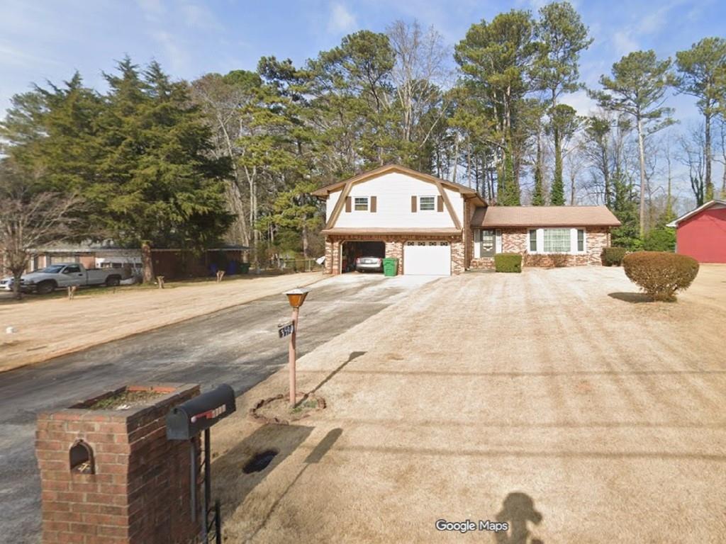 a view of a white house with a yard
