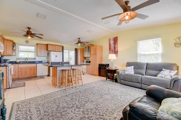 a living room with furniture and a chandelier