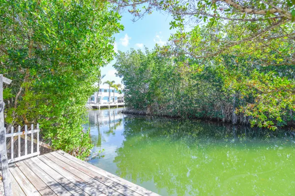 a view of a lake with a house in the background