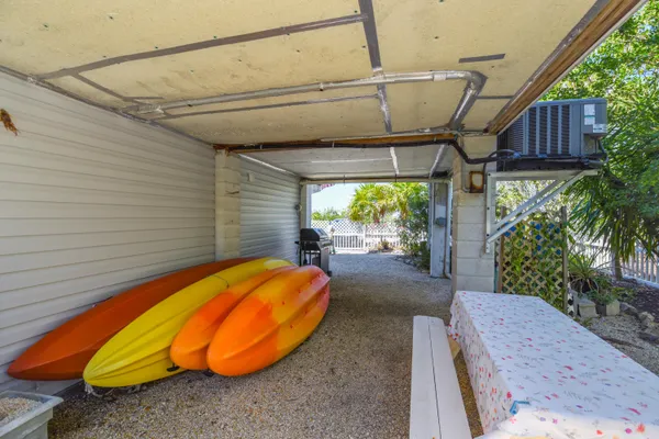 a view of a backyard with a tub and chair in the patio