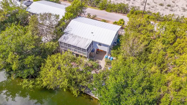 an aerial view of a house with a yard swimming pool and outdoor seating
