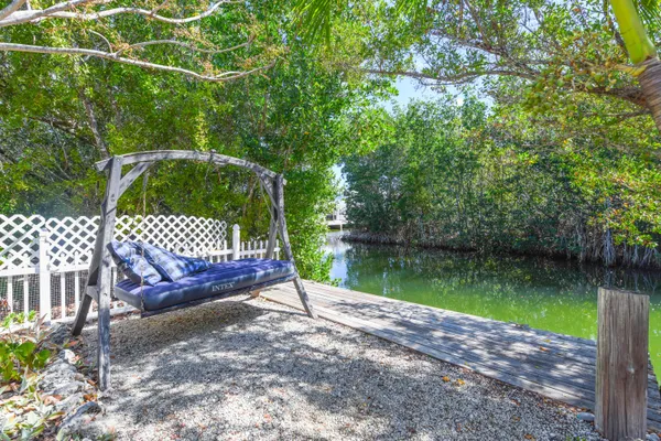 a park view with a wooden bridge