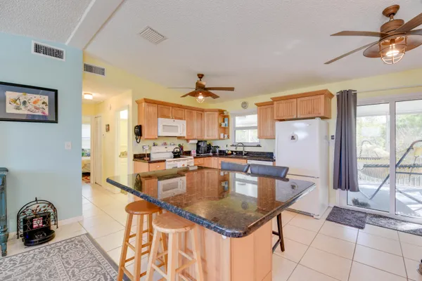 a kitchen with stainless steel appliances granite countertop a sink a stove and a refrigerator