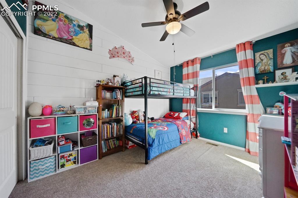 1546 York Road Colorado Springs, CO 80920 - Photo 16 of 23 a bedroom with lots of baby toys and a baby crib