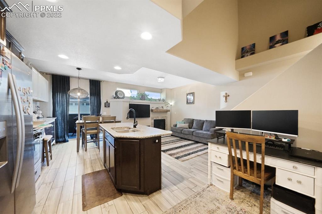1546 York Road Colorado Springs, CO 80920 - Photo 4 of 23 a living room with furniture a flat screen tv and a refrigerator