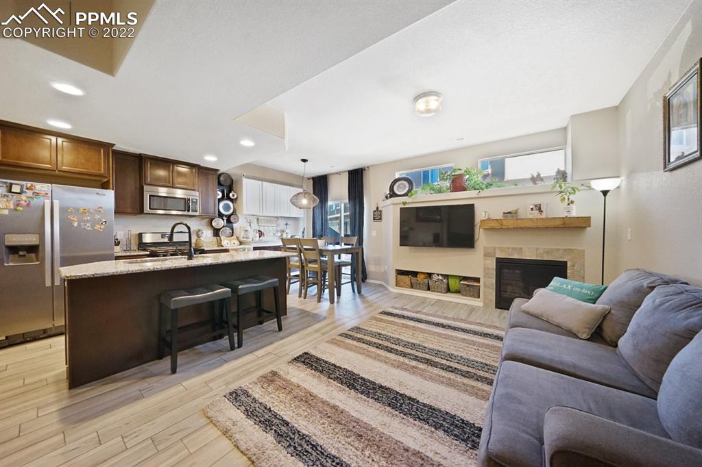 1546 York Road Colorado Springs, CO 80920 - Photo 5 of 23 a living room with furniture a flat screen tv and a fireplace