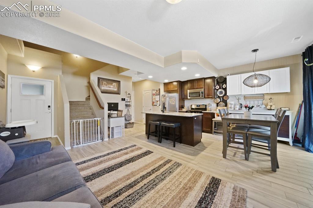 1546 York Road Colorado Springs, CO 80920 - Photo 6 of 23 a living room with furniture and a wooden floor
