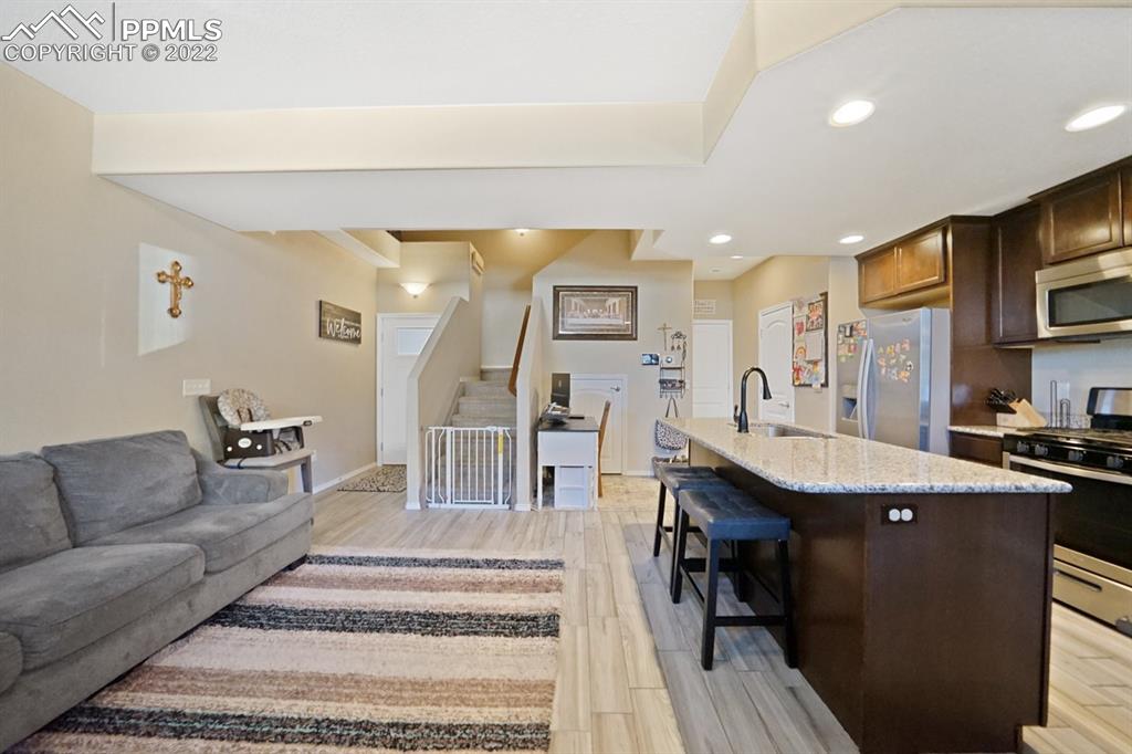 1546 York Road Colorado Springs, CO 80920 - Photo 7 of 23 a living room with stainless steel appliances kitchen island granite countertop furniture and a kitchen view