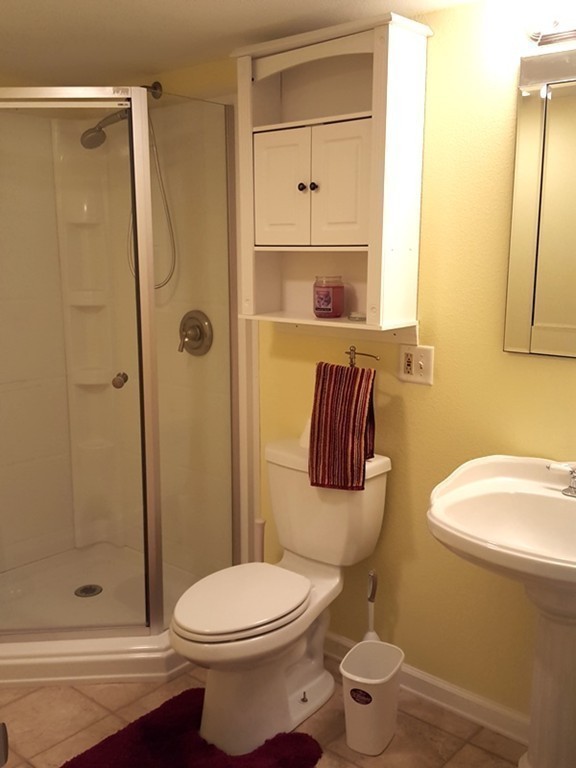 62 Corey Road Springfield, MA 01128 - Photo 15 of 26 a bathroom with a toilet and a shower