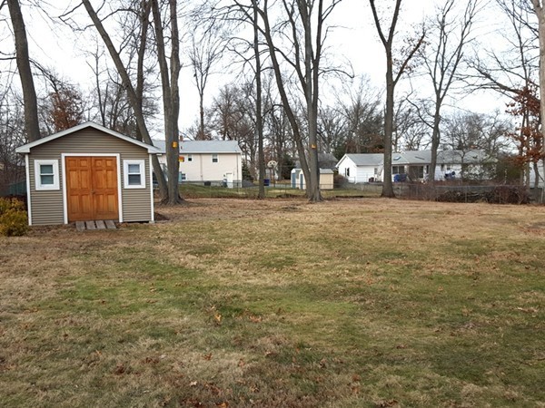62 Corey Road Springfield, MA 01128 - Photo 24 of 26 a white house that has a tree in front of it
