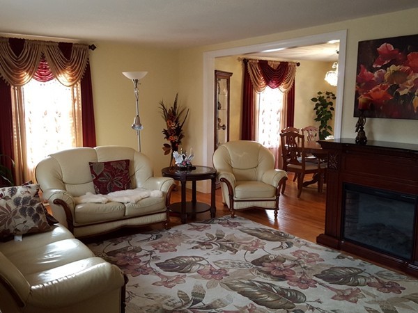62 Corey Road Springfield, MA 01128 - Photo 3 of 26 a living room with furniture a window and a fireplace