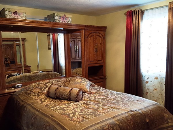 62 Corey Road Springfield, MA 01128 - Photo 9 of 26 a bedroom with a large bed and a closet