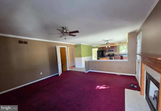 a view of a livingroom with a kitchen
