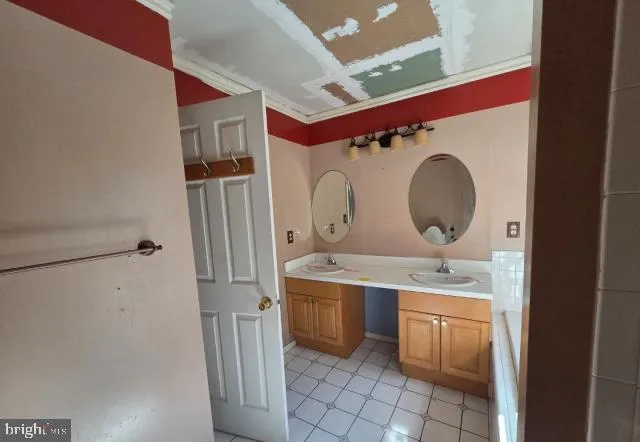 a room with a stove a sink and a mirror