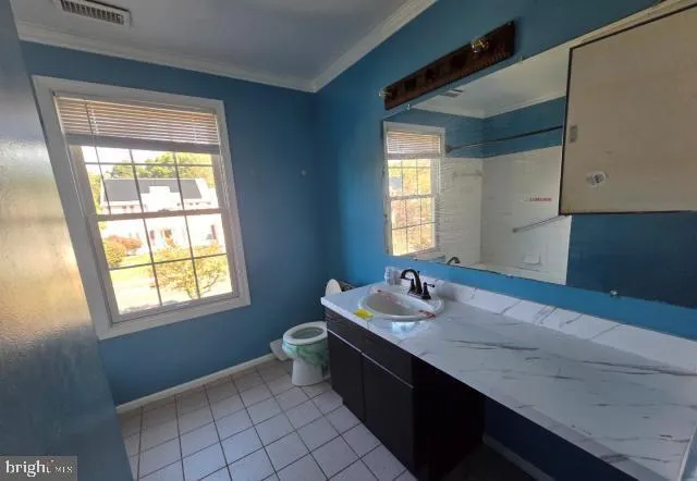 a bathroom with a double vanity sink and a window
