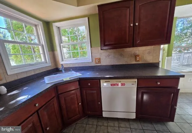 a kitchen with stainless steel appliances granite countertop wooden cabinets a sink and a window