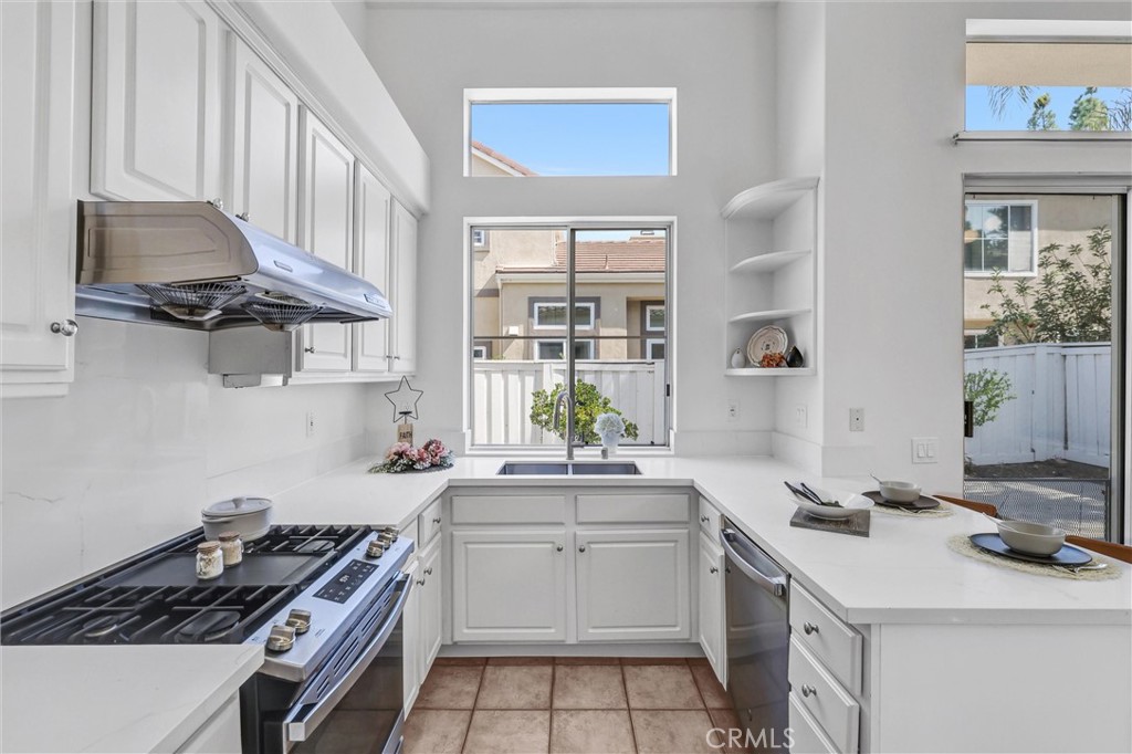 35 Del Cambrea Irvine, CA 92606 - Photo 11 of 31 a kitchen with a sink stove top oven and cabinets