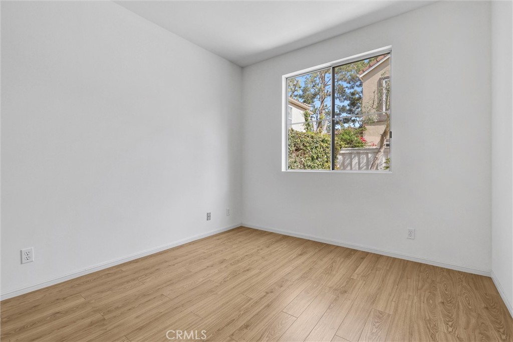 35 Del Cambrea Irvine, CA 92606 - Photo 12 of 31 an empty room with wooden floor and windows