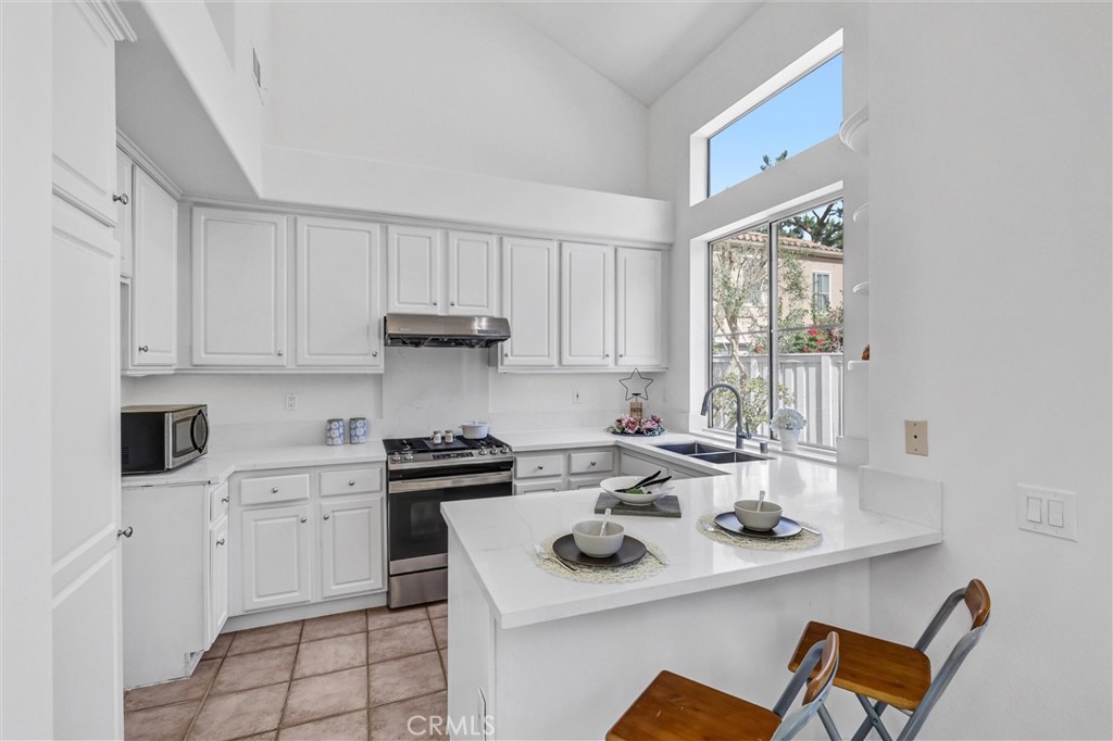 35 Del Cambrea Irvine, CA 92606 - Photo 9 of 31 a kitchen with a sink cabinets and window