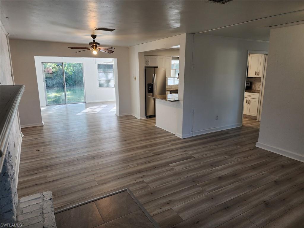 200 Willoughby Drive Naples, FL 34110 - Photo 13 of 15 Unfurnished living room featuring ceiling fan and dark hardwood / wood-style floors
