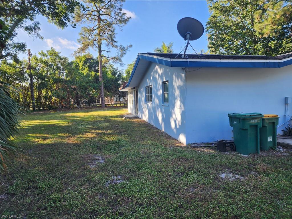 200 Willoughby Drive Naples, FL 34110 - Photo 14 of 15 View of side of home with a yard