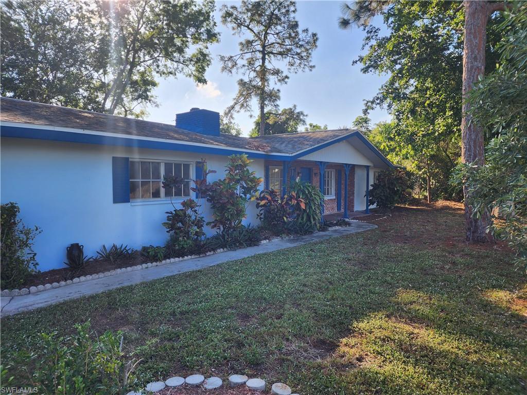 200 Willoughby Drive Naples, FL 34110 - Photo 2 of 15 View of front of property featuring a front yard