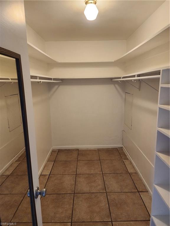 200 Willoughby Drive Naples, FL 34110 - Photo 6 of 15 Spacious closet with dark tile patterned flooring