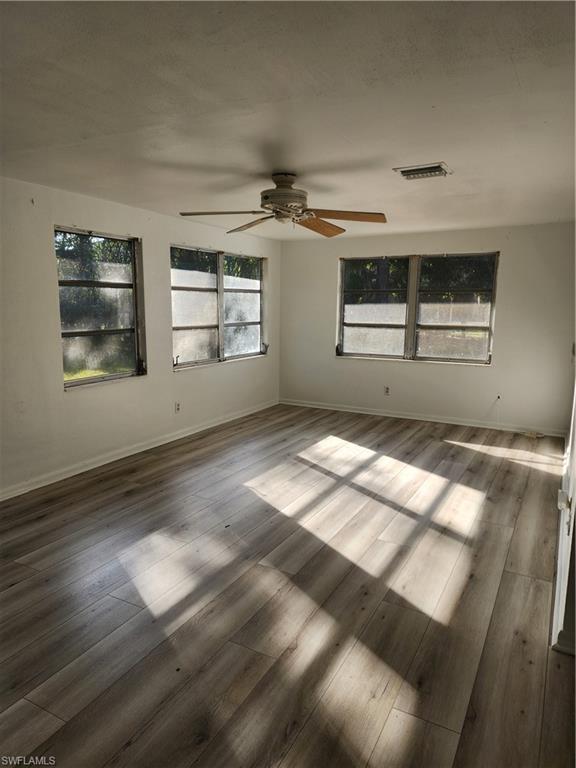 200 Willoughby Drive Naples, FL 34110 - Photo 8 of 15 Unfurnished room with ceiling fan and hardwood / wood-style floors