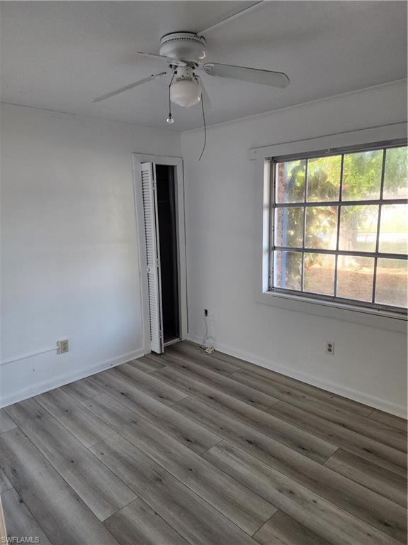 200 Willoughby Drive Naples, FL 34110 - Photo 9 of 15 Empty room featuring ceiling fan and hardwood / wood-style flooring