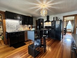 168 Wheatland Avenue, Unit 2 Chicopee, MA 01020 - Photo 4 of 15 a kitchen with stainless steel appliances granite countertop a stove refrigerator and cabinets