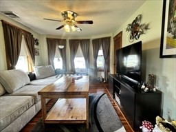 168 Wheatland Avenue, Unit 2 Chicopee, MA 01020 - Photo 8 of 15 a living room with furniture and a flat screen tv