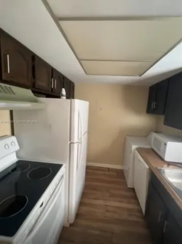 a kitchen with a refrigerator sink and stove