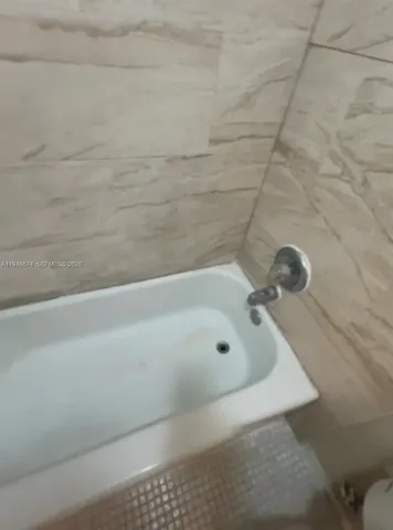 a bathroom with a bath tub